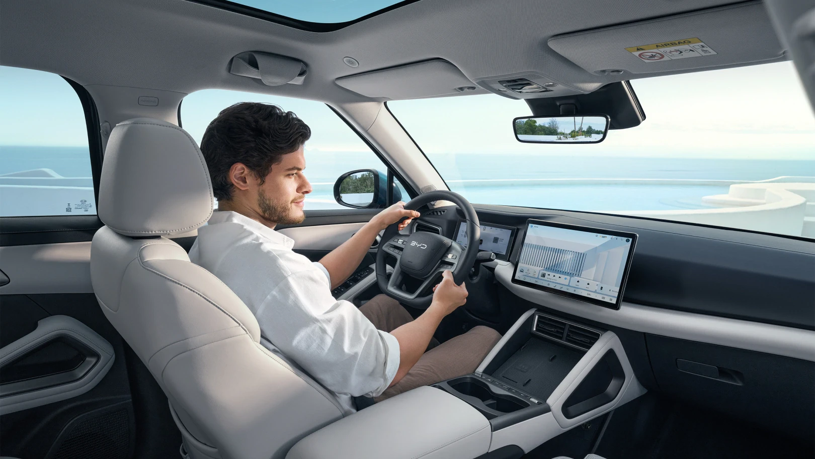 Image of man sat in driving seat of BYD ATTO 2 DM-i